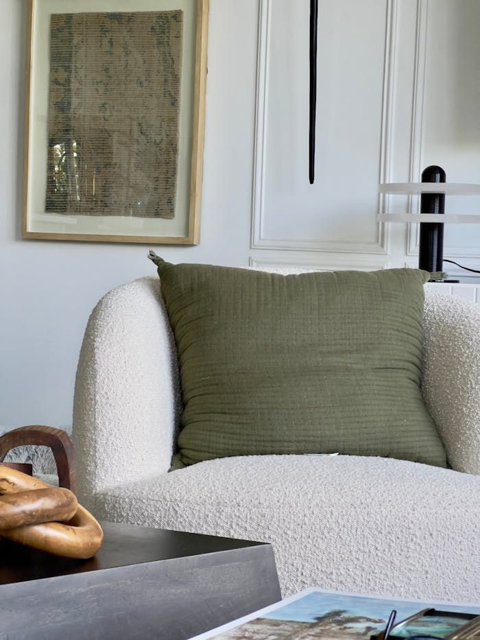 why-choose-us Chic armchair with green cushion in a modern living room setting, perfect for home decor inspiration.